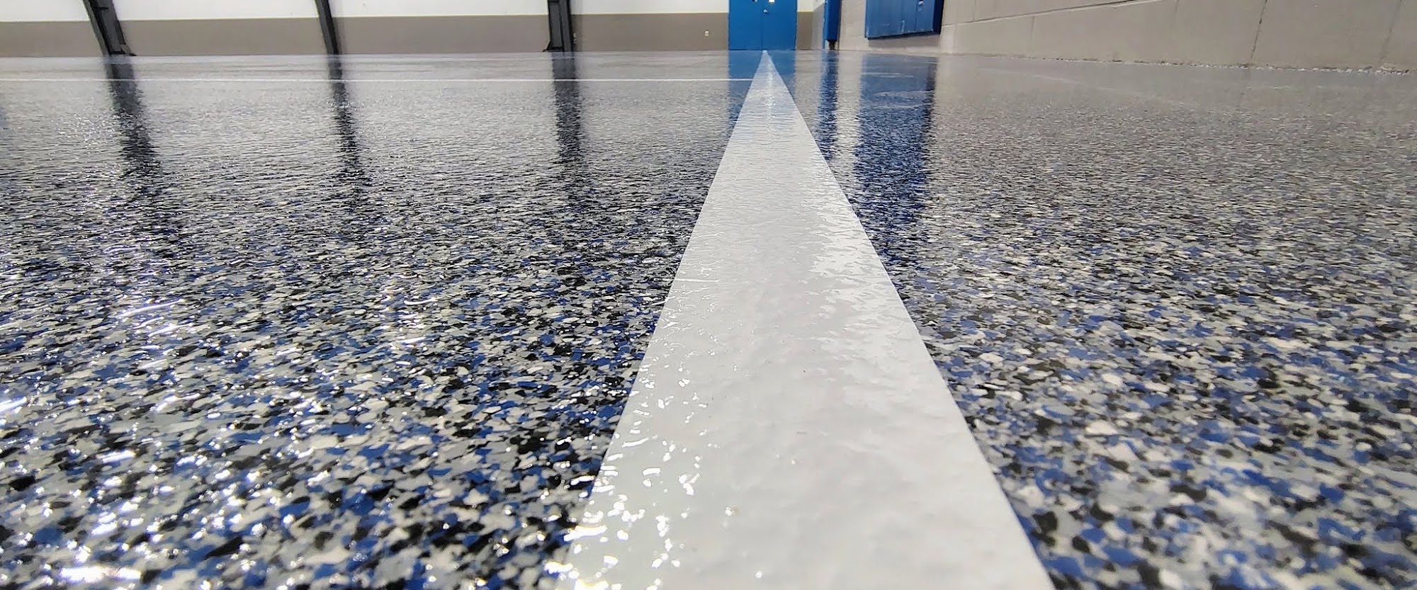 Close-up of a blue, black, and white flake floor