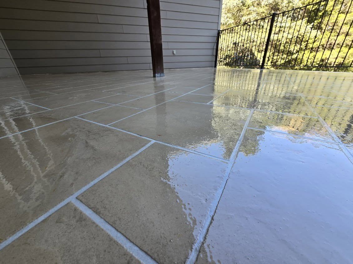 Tile-pattern concrete overlay patio with a high-gloss sealer in Columbia, MO