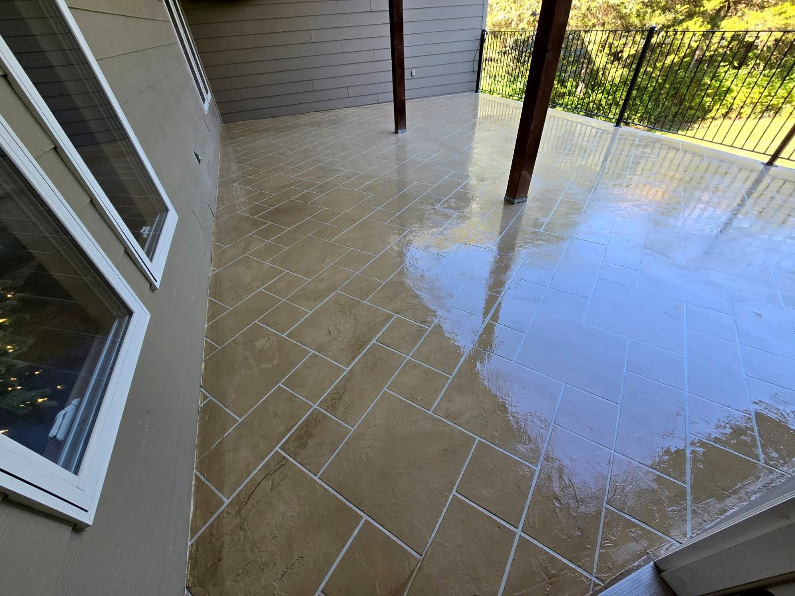 Tile-pattern concrete overlay on a covered patio