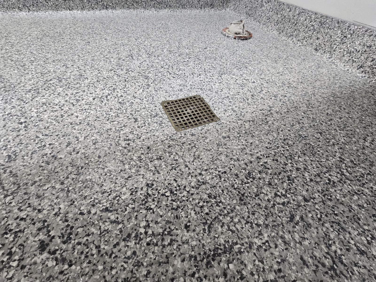 Rebuilt floor drain in a coated flake floor