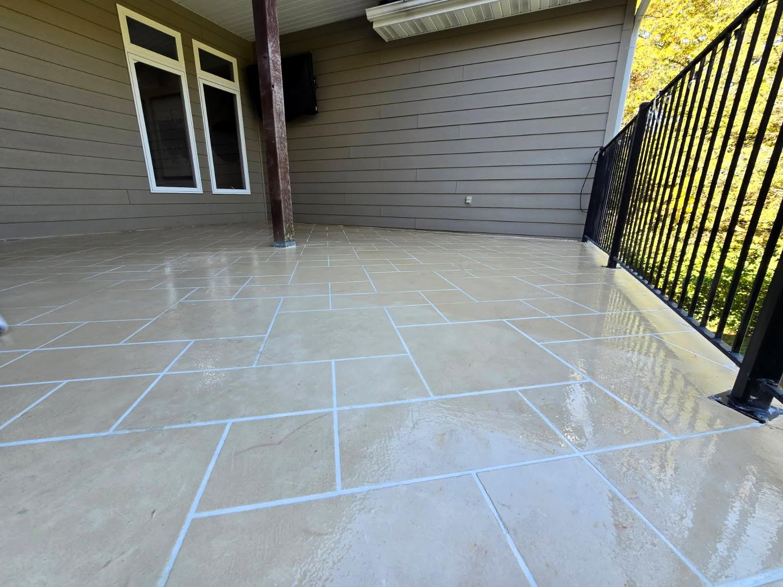 Tile-pattern concrete overlay on a covered patio