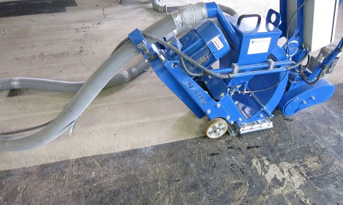 Shot blaster removing an old floor coating down to bare concrete.